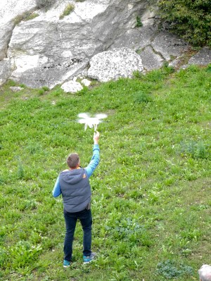 This young man is not catching a bird but an airborne camera. It flew off up and around one of San Marino's towers. Talking to the upper crust young English men it can fly 2 km away and compensates for wind etc. 