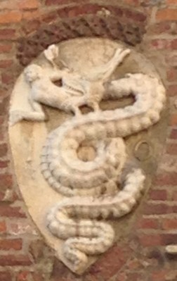 Milan's coat of arms ... a serpent eating the Muslim that Visconti defatted .. he got the keep the cat of arms