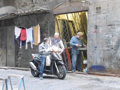 Street scene ... moped, blokes chewing the fat and a craftsman.
