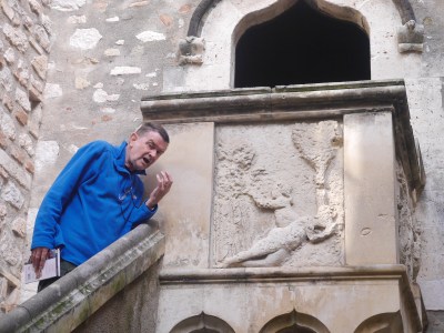 J is Adam, eating Eve's apple .... it is the carving on the balcony.