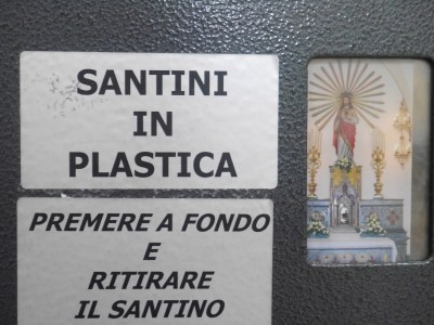 Inside the Duomo: Buy your own plastic saint!!! Otherwise stare at the Cardinal's corpse - face mask but withered bejewelled hands.